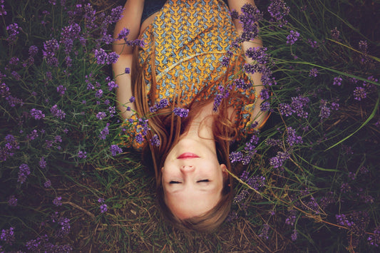 Woman lying down in field with flowers
